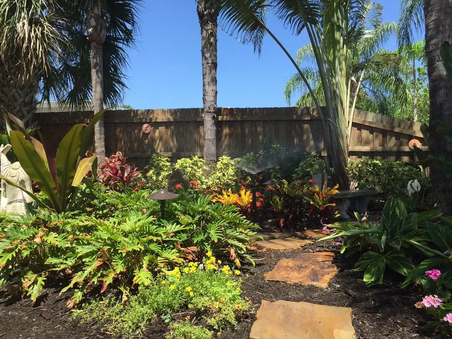 A Hartmann zone running through a tropical planting bed, pop up head spraying across crotons and bromeliads